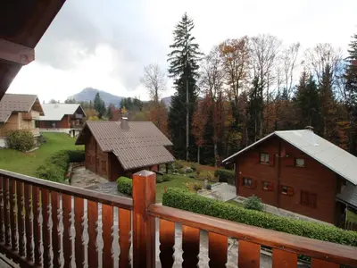 a view from a balcony of a house and a barn at Chalet équipé avec poêle et garage, proche centre et remontées mécaniques - FR-1-572-107 in Les Carroz d'Araches