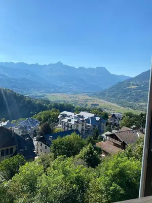 a view of a town with mountains in the background at Studio magnifique saint Gervais les bains in Saint-Gervais-les-Bains