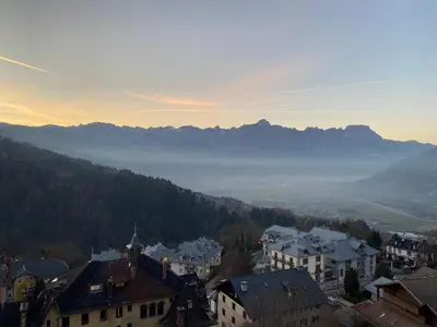 a view of a city with mountains in the distance at Studio magnifique saint Gervais les bains in Saint-Gervais-les-Bains