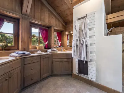 a bathroom with two sinks and two mirrors at Chalet familial à Megève avec piscine et sauna pour 12 personnes - FR-1-569-2 in Megève