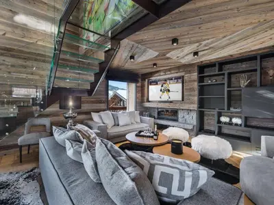 a living room with couches and a tv in a house at Chalet de luxe avec jacuzzi, salle cinéma et piscine au centre de Megève - FR-1-569-10 in Megève