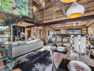 a living room with a couch and a table at Chalet de luxe avec jacuzzi, salle cinéma et piscine au centre de Megève - FR-1-569-10 in Megève
