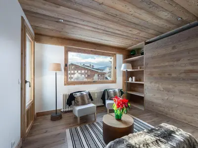 a living room with wooden walls and a couch and chairs at Charmant appartement au Mont d'Arbois proche pistes, parking inclus - FR-1-569-11 in Megève