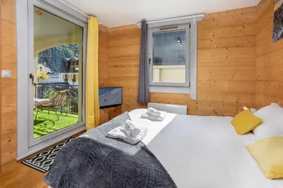 a bedroom with a large bed and a window at Le Paradis 25 Apartment - Chamonix All Year in Chamonix-Mont-Blanc