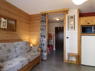 a living room with a couch and a kitchen at Studio rénové cosy, 4 pers, au pied des pistes, balcon ouest, proche commerces, parking inclus - FR-1-572-66 in Les Carroz d'Araches