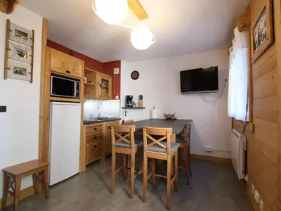 a kitchen with a table and chairs and a refrigerator at Studio rénové cosy, 4 pers, au pied des pistes, balcon ouest, proche commerces, parking inclus - FR-1-572-66 in Les Carroz d'Araches