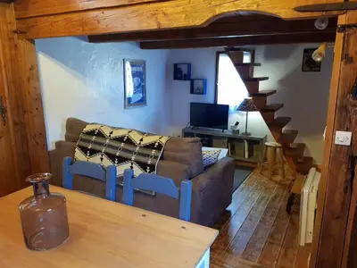 a living room with a couch and a table at Petit chalet savoyard in Domancy
