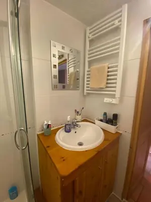 a kitchen with a table with a box on the floor at Jardin des Neiges - 11A in Samoëns