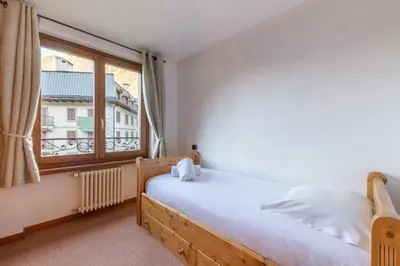 a bedroom with a bed and a large window at DIFY René Payot - Chamonix-Mont-Blanc in Chamonix-Mont-Blanc