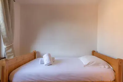 a bed with a towel sitting on top of it at DIFY René Payot - Chamonix-Mont-Blanc in Chamonix-Mont-Blanc