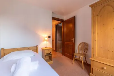 a bedroom with a bed and a table and a chair at DIFY René Payot - Chamonix-Mont-Blanc in Chamonix-Mont-Blanc