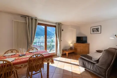 a living room with a table and a couch at DIFY René Payot - Chamonix-Mont-Blanc in Chamonix-Mont-Blanc