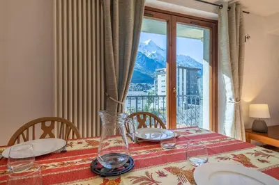 a dining room table with a view of a mountain at DIFY René Payot - Chamonix-Mont-Blanc in Chamonix-Mont-Blanc