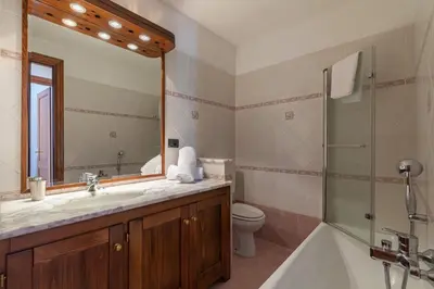 a bathroom with a sink and a toilet and a mirror at DIFY René Payot - Chamonix-Mont-Blanc in Chamonix-Mont-Blanc