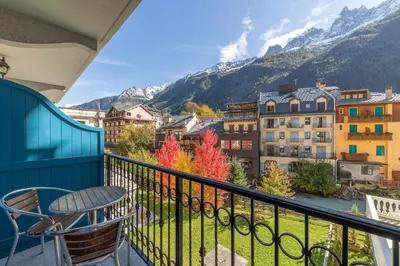 a balcony with a table and a view of mountains at DIFY Paccard - Chamonix-Mont-Blanc in Chamonix-Mont-Blanc