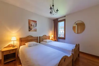 a bedroom with two white beds and a window at DIFY Paccard - Chamonix-Mont-Blanc in Chamonix-Mont-Blanc