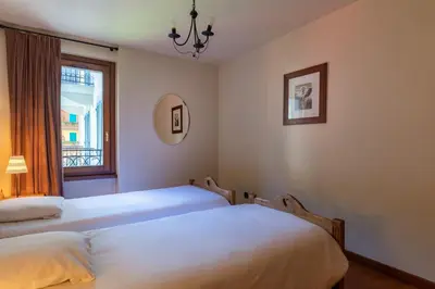 two beds in a room with a window at DIFY Paccard - Chamonix-Mont-Blanc in Chamonix-Mont-Blanc