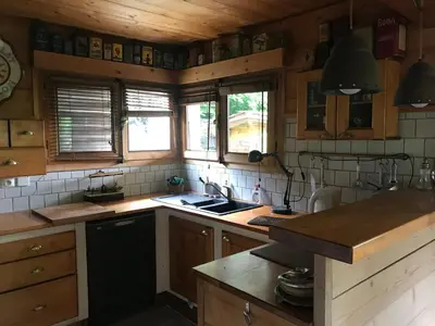 a kitchen with wooden cabinets and a sink and a stove at Le Solli in Saint-Gervais-les-Bains
