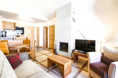 a living room with a couch and a fireplace at Les Terrasses d'Eos, 1-bed apartment with fireplace, Ski in, Ski out in Flaine