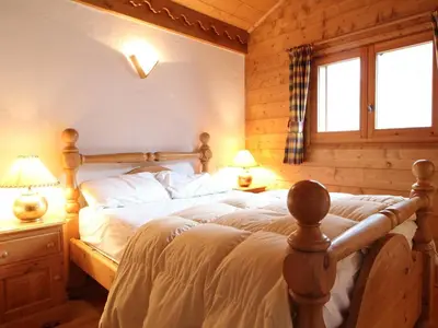 a bedroom with a bed and two lamps and a window at Chalet 4 pièces + mezzanine, 8 pers, WiFi, parking, proche spa, arrêt ski-bus - FR-1-572-112 in Les Carroz d'Araches