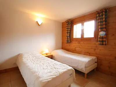 a bedroom with two beds and a window at Chalet 4 pièces + mezzanine, 8 pers, WiFi, parking, proche spa, arrêt ski-bus - FR-1-572-112 in Les Carroz d'Araches