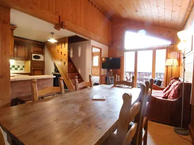 a dining room with a wooden table and chairs at Chalet 4 pièces + mezzanine, 8 pers, WiFi, parking, proche spa, arrêt ski-bus - FR-1-572-112 in Les Carroz d'Araches