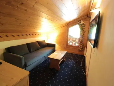 a living room with a couch and a table at Chalet 4 pièces + mezzanine, 8 pers, WiFi, parking, proche spa, arrêt ski-bus - FR-1-572-112 in Les Carroz d'Araches