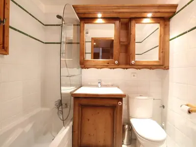 a bathroom with a sink and a toilet and a mirror at Chalet 4 pièces + mezzanine, 8 pers, WiFi, parking, proche spa, arrêt ski-bus - FR-1-572-112 in Les Carroz d'Araches