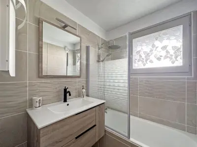a bathroom with a sink and a shower and a mirror at CA116 Studio 4 Pers centre des Carroz in Les Carroz d'Araches