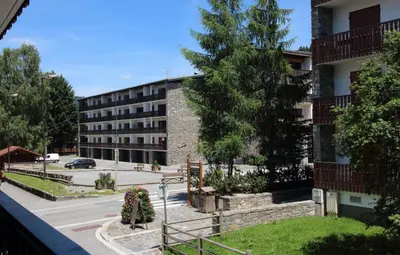 an apartment building with a parking lot in front of it at CA116 Studio 4 Pers centre des Carroz in Les Carroz d'Araches