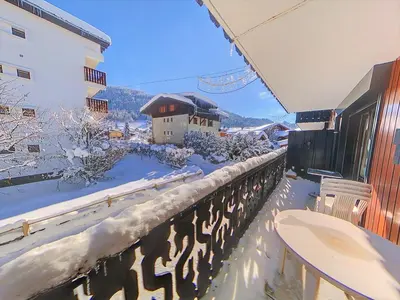 a balcony covered in snow with a building in the background at CA116 Studio 4 Pers centre des Carroz in Les Carroz d'Araches