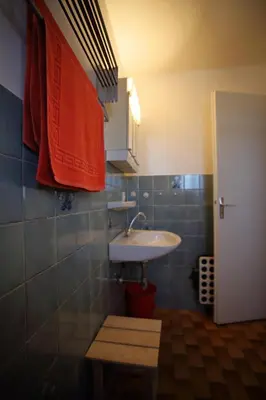 a bathroom with a sink and a mirror and a door at PE255 Studio 4 pers pieds de piste in Les Carroz d'Araches