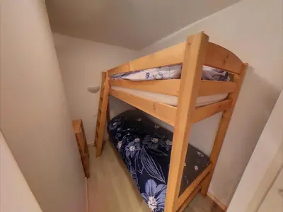 a bunk bed in the corner of a room at VAR50 - Studio 4 Pers centre des Carroz in Les Carroz d'Araches