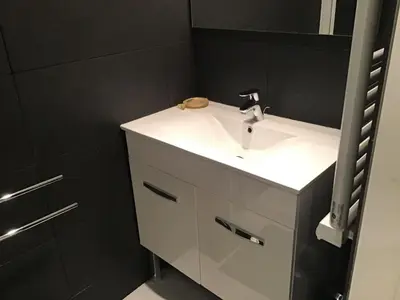 a bathroom with a white sink and a mirror at VAR50 - Studio 4 Pers centre des Carroz in Les Carroz d'Araches