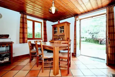 a dining room with a wooden table and chairs at Chalet Ulysse - Chalet Ulysse MAE-6403 in Les Houches