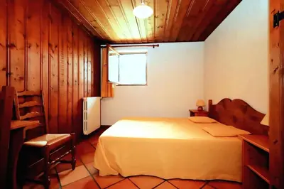 a bedroom with a large bed and a window at Chalet Ulysse - Chalet Ulysse MAE-6403 in Les Houches