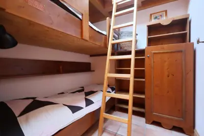 a bunk bed with a ladder in a room at Résidence Les Hauts De Chavants - Hauts de Chavants Albert 1er 13 MAE-6404 in Les Houches