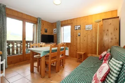 a kitchen and dining room with a table and a couch at Résidence Le Saint Georges - Saint-Georges 07 MAE-6405 in Les Houches