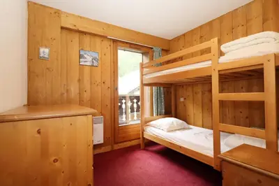 a bedroom with two bunk beds and a window at Résidence Le Saint Georges - Saint-Georges 07 MAE-6405 in Les Houches