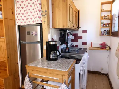 a small kitchen with a stainless steel refrigerator at Résidence Aiguille Du Midi Bat A - Aiguille du Midi A778 MAE-6406 in Les Houches