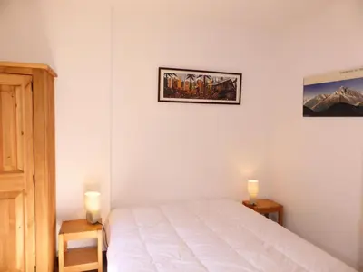 a bedroom with a bed and two candles on two tables at Résidence Aiguille Du Midi Bat A - Aiguille du Midi A778 MAE-6406 in Les Houches