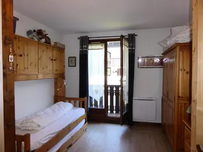a bedroom with a bed and a large window at Résidence Aiguille Du Midi Bat A - Aiguille du Midi A778 MAE-6406 in Les Houches