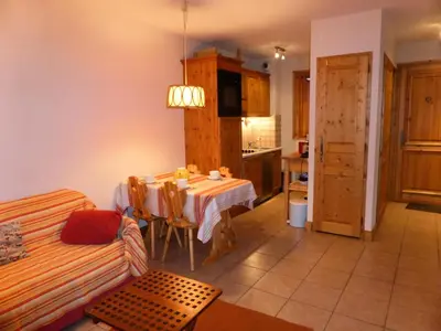 a living room with a table and a kitchen at Résidence Les Amethystes B - Améthystes B02 MAE-6409 in Les Houches