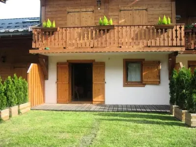 a house with a balcony with potted plants on it at Résidence Les Amethystes B - Améthystes B02 MAE-6409 in Les Houches
