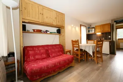 a living room with a red couch and a table at Résidence Le Prarion 2 C - Prarion 2 Bât A MAE-6413 in Les Houches