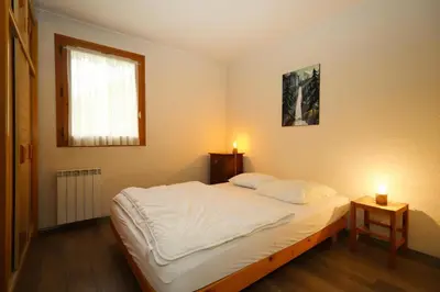 a bedroom with a bed with two candles on it at Résidence Le Prarion 2 C - Prarion 2 Bât A MAE-6413 in Les Houches