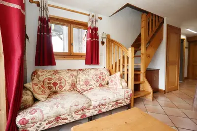 a living room with a couch and a staircase at Résidence Les Hauts De Chavants - Hauts de Chavants Vallot 3 MAE-6414 in Les Houches