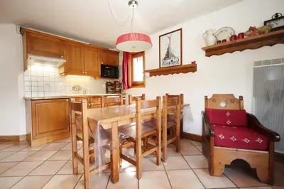a kitchen with a wooden dining room table and chairs at Résidence Les Hauts De Chavants - Hauts de Chavants Vallot 3 MAE-6414 in Les Houches