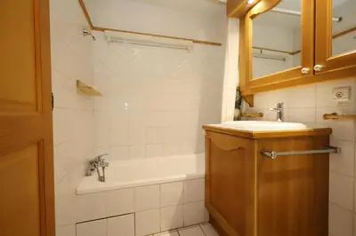 a bathroom with a tub and a sink and a mirror at Résidence Les Hauts De Chavants - Hauts de Chavants Vallot 3 MAE-6414 in Les Houches