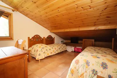 a bedroom with two beds and a wooden ceiling at Résidence Les Hauts De Chavants - Hauts de Chavants Vallot 3 MAE-6414 in Les Houches